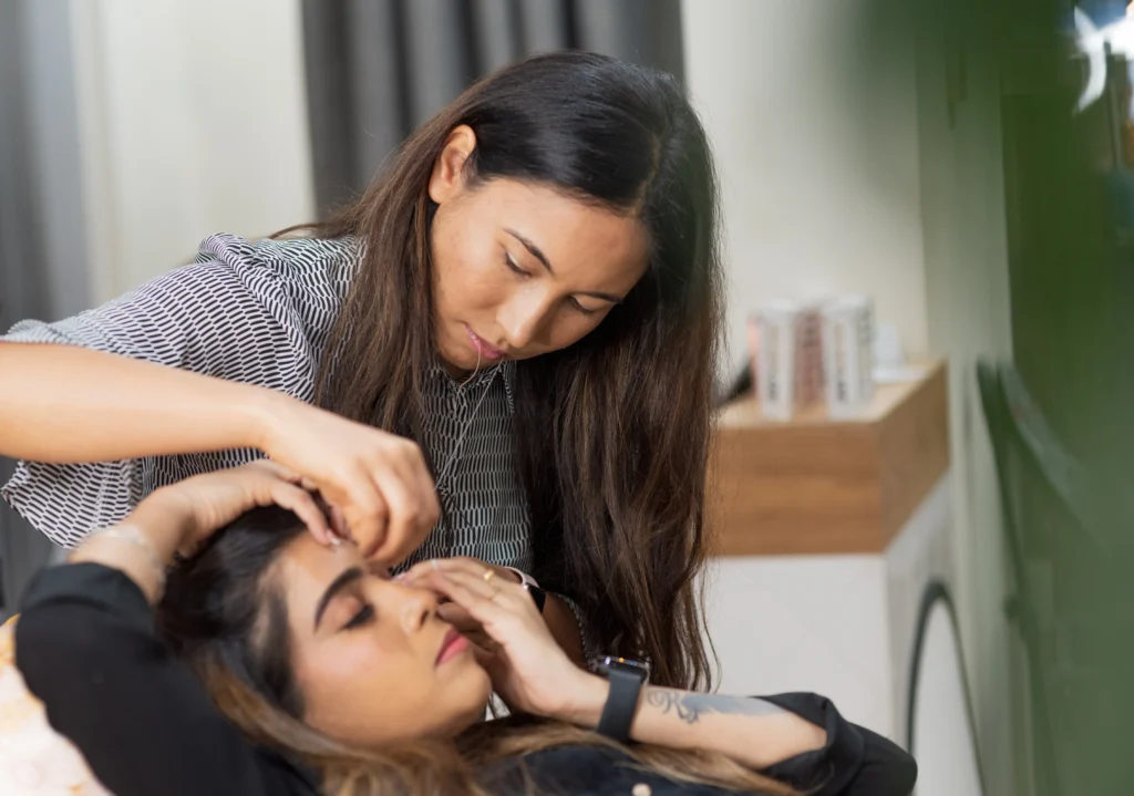 Lash tech as Lash Bar Darwin offering a brow service to client.